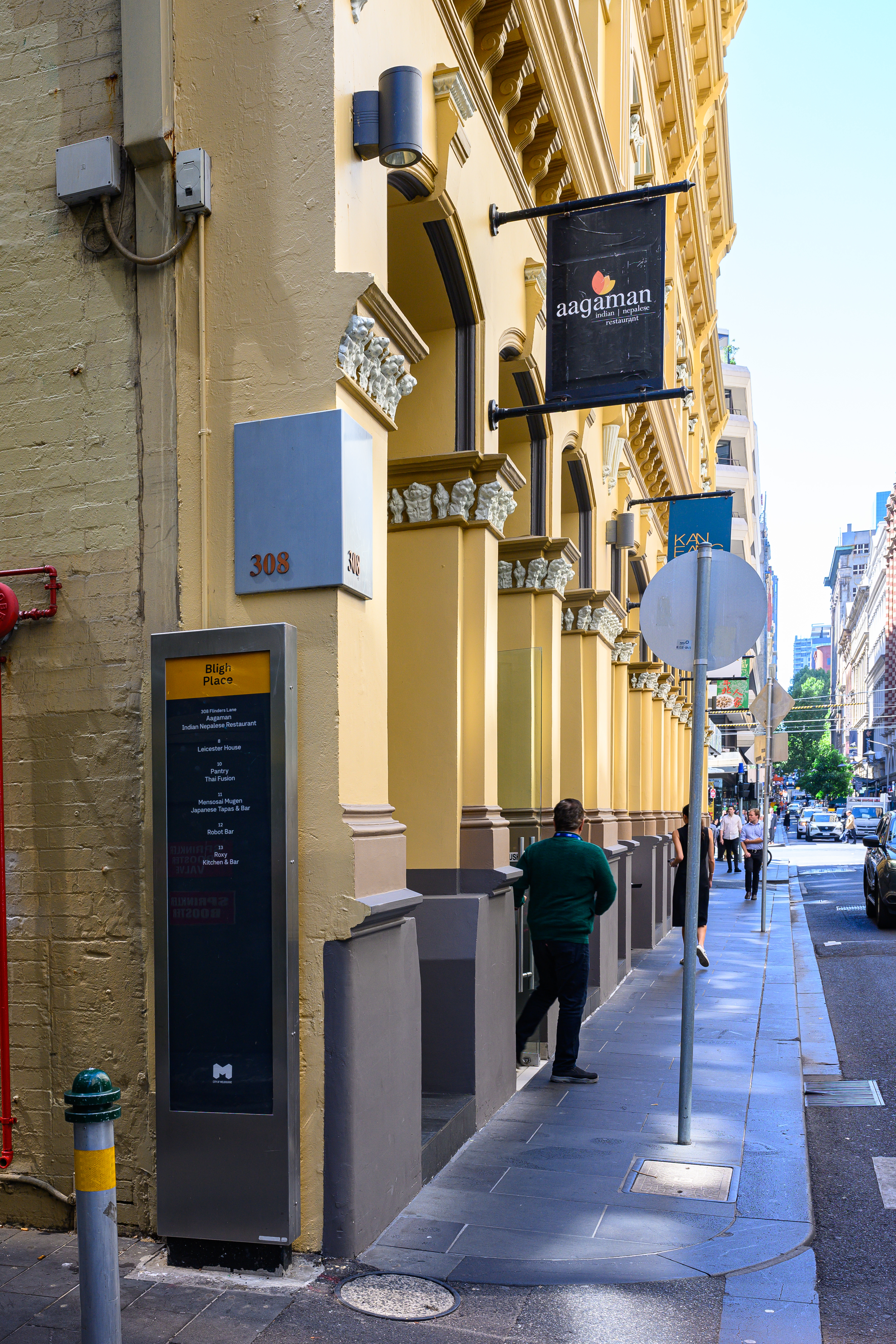 Aagaman Flinders Lane — CBD dining room with gold pendants and cityscape mural
