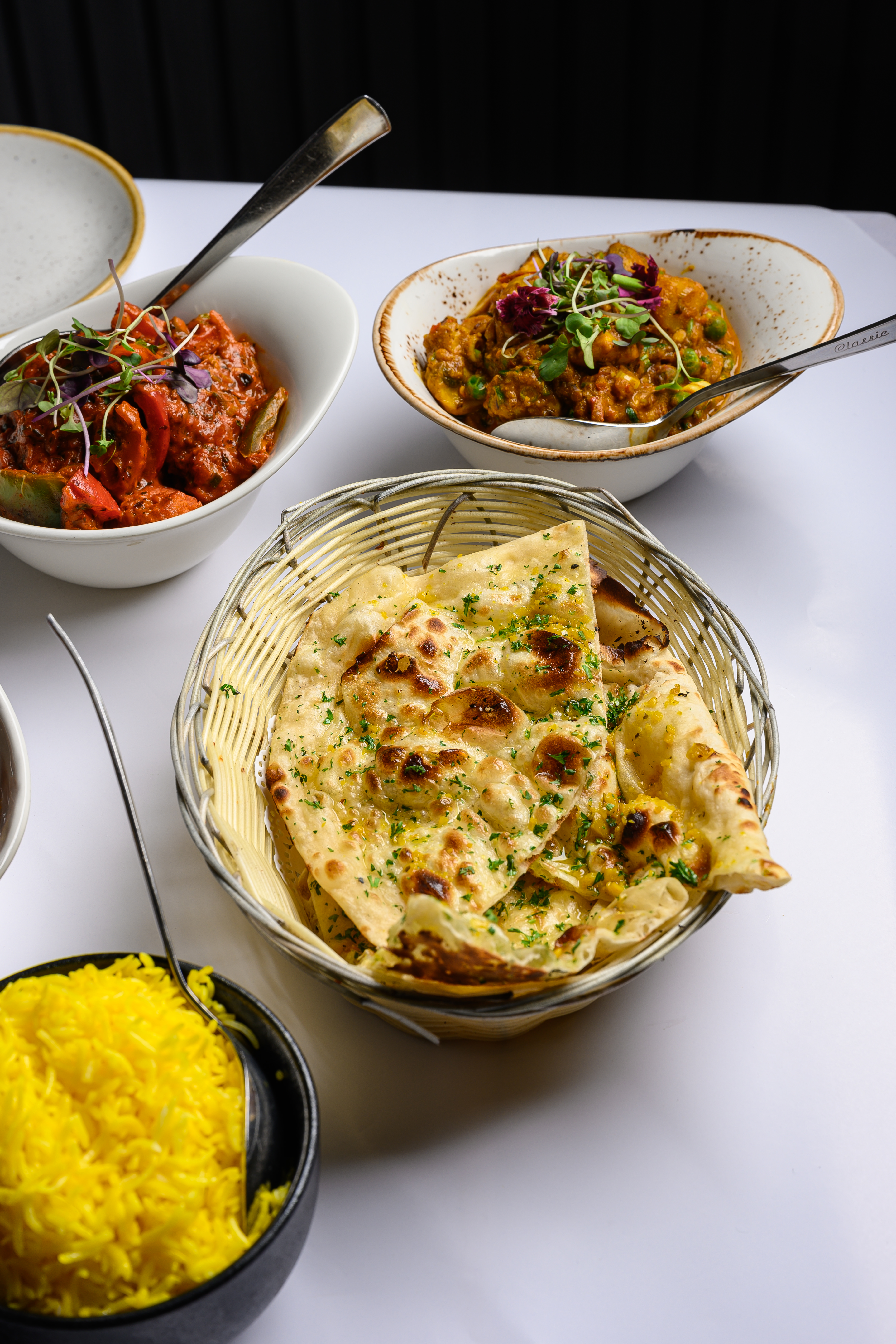 Aagaman — naan, curries and rice spread at the table
