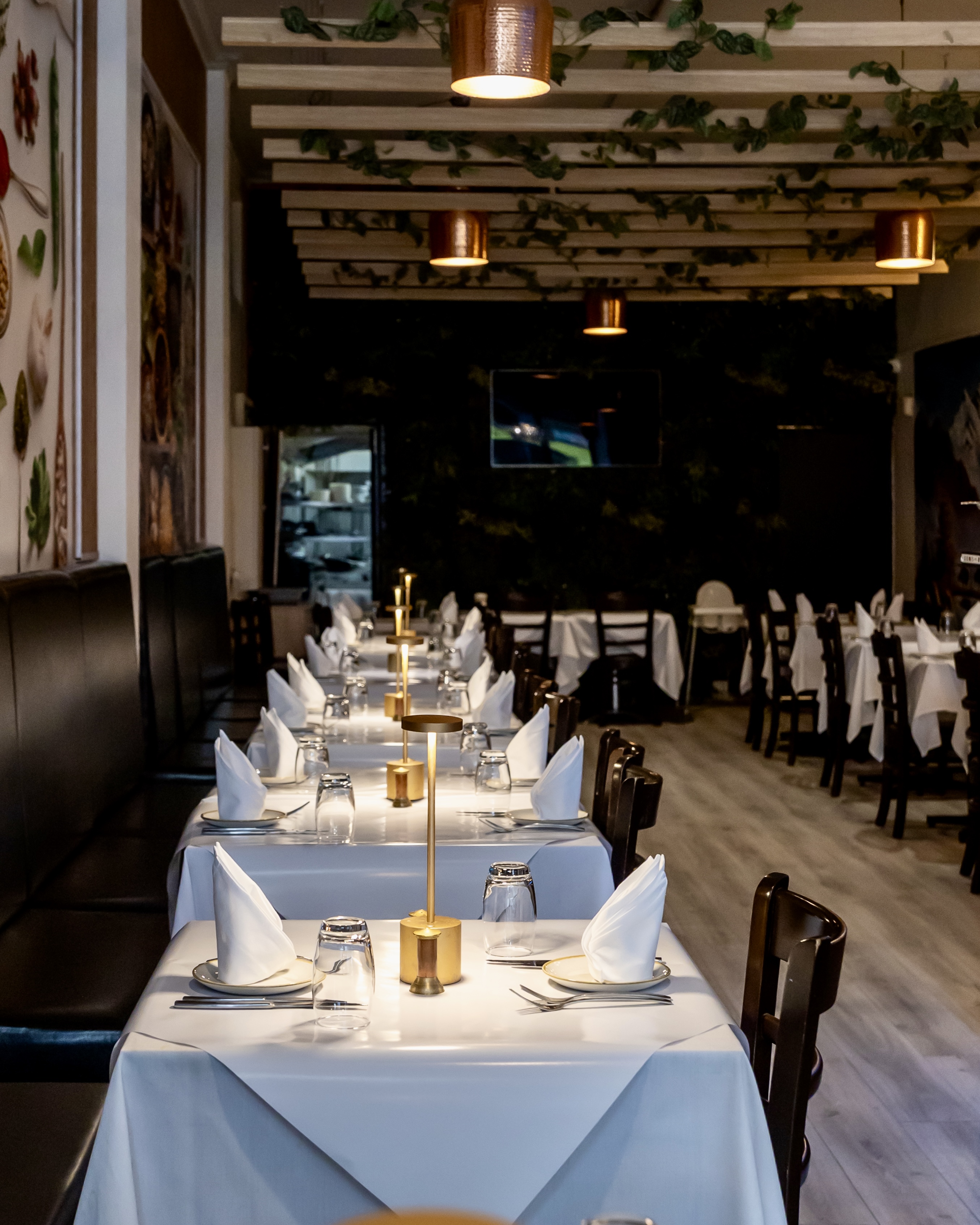 Aagaman Port Melbourne — dining room with wine display and Himalayan artwork